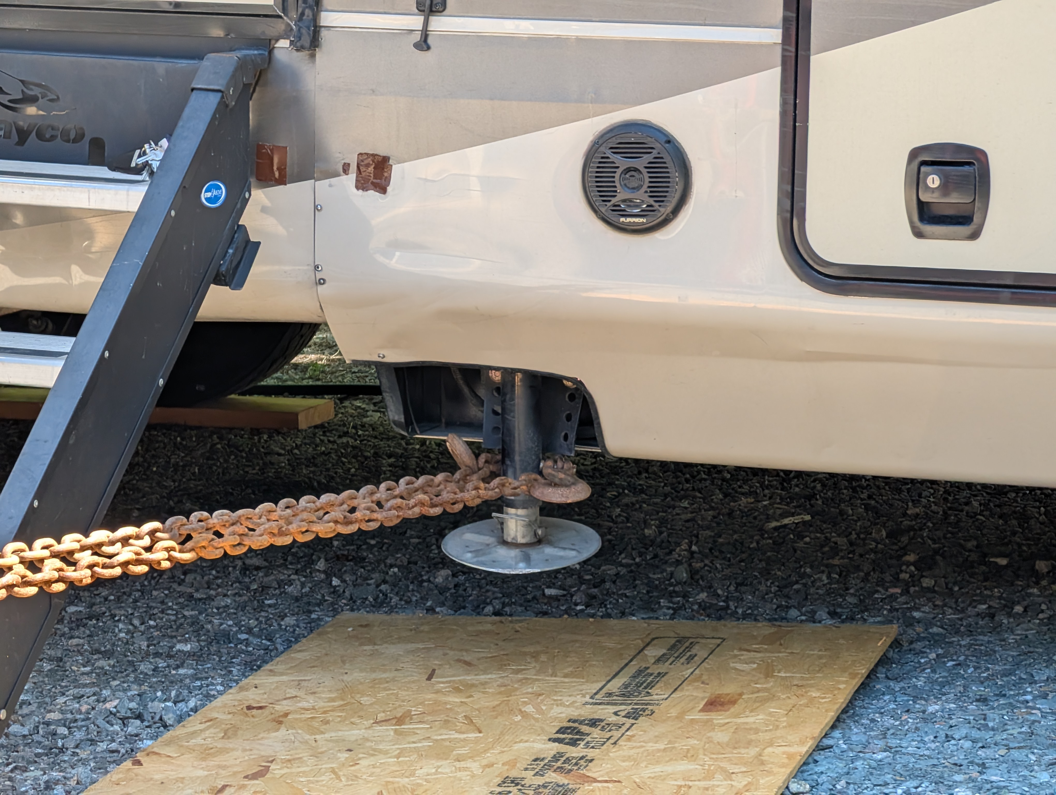 A taut chain wrapped around an RV stabilizer