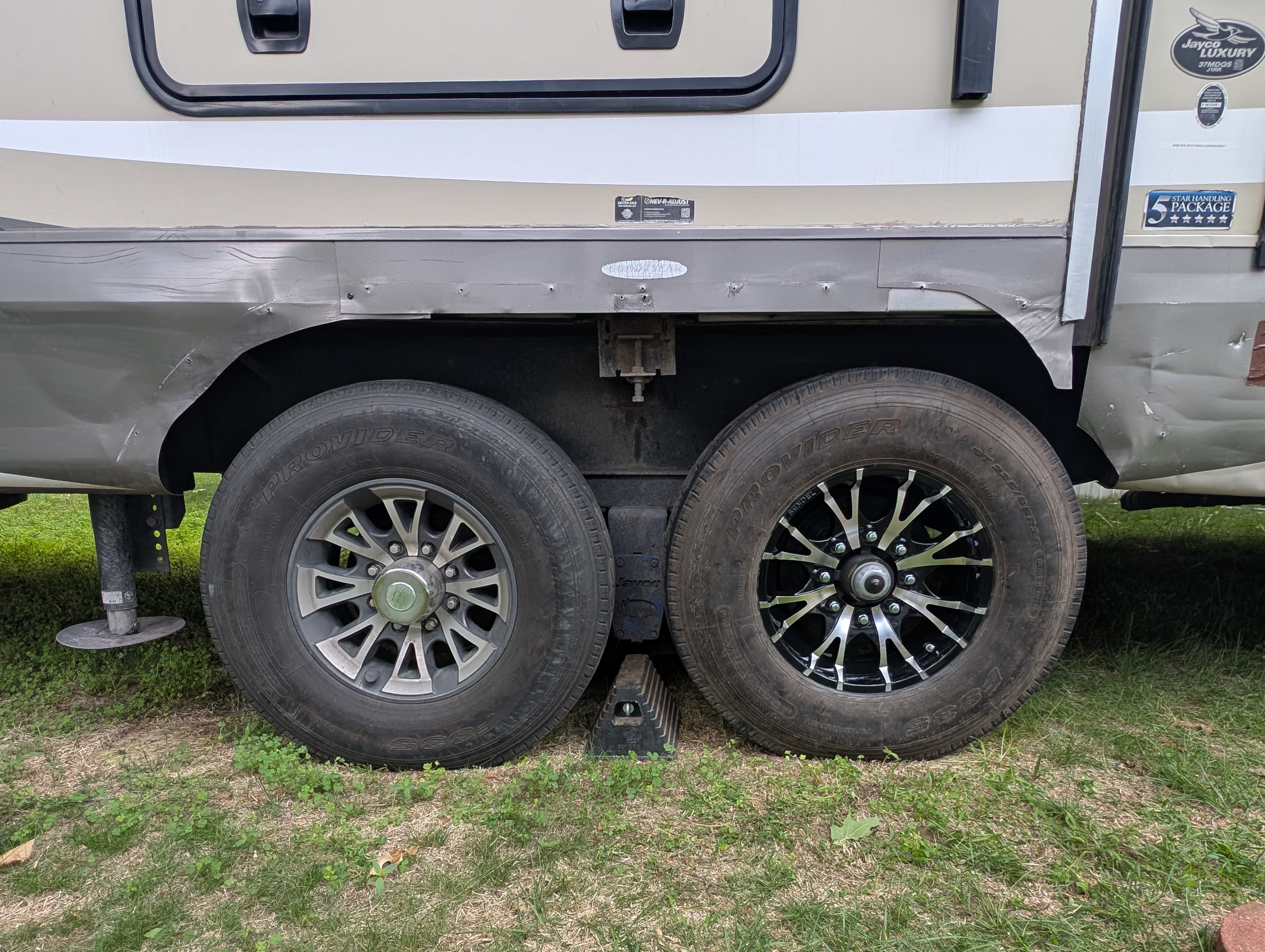 Two trailer tires with nearly matching rims