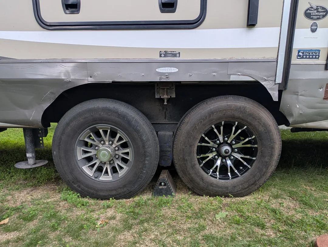 Two trailer tires with nearly matching rims