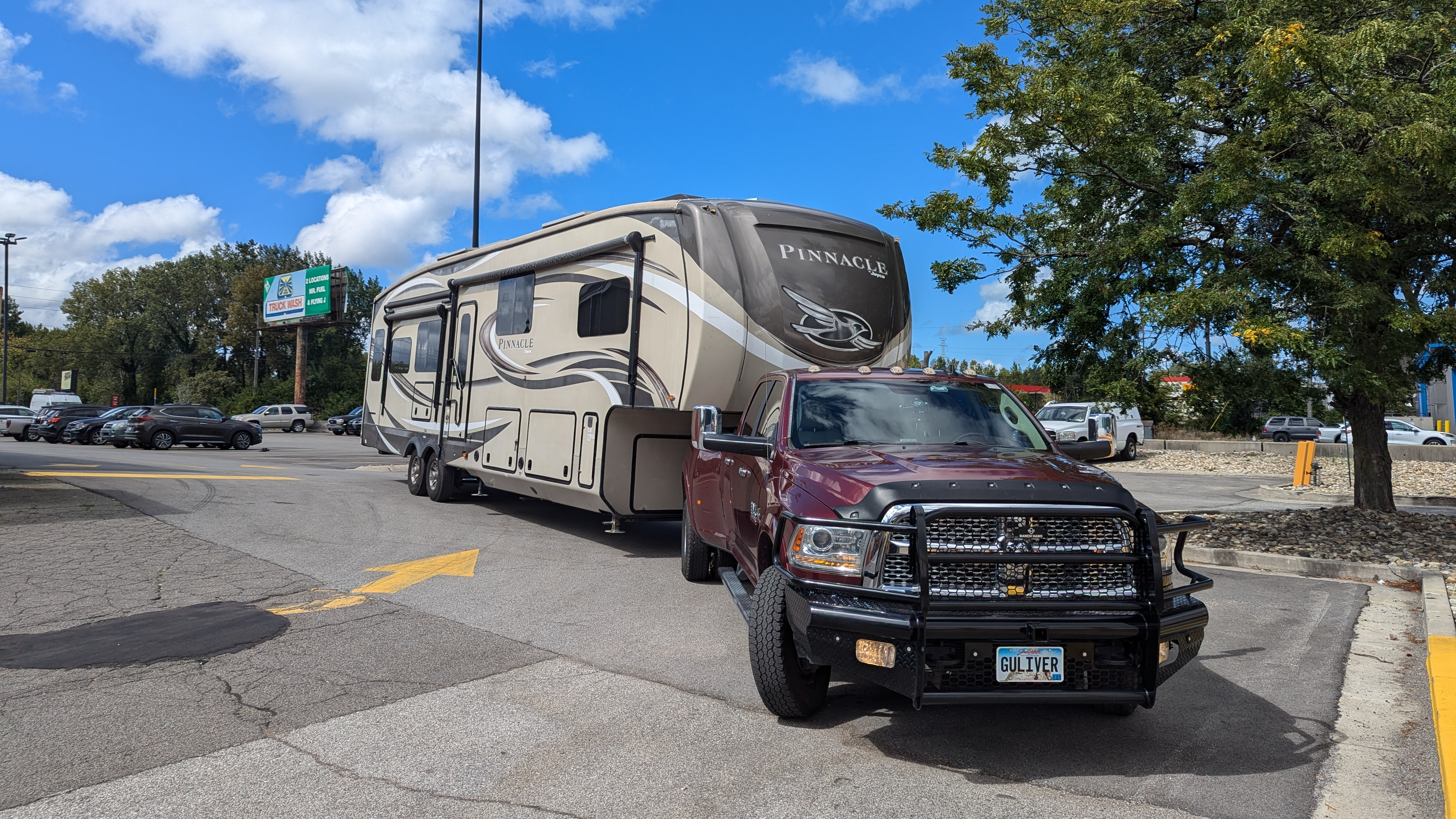 Red dually truck pulling a Jayco Pinnacle fifth wheel