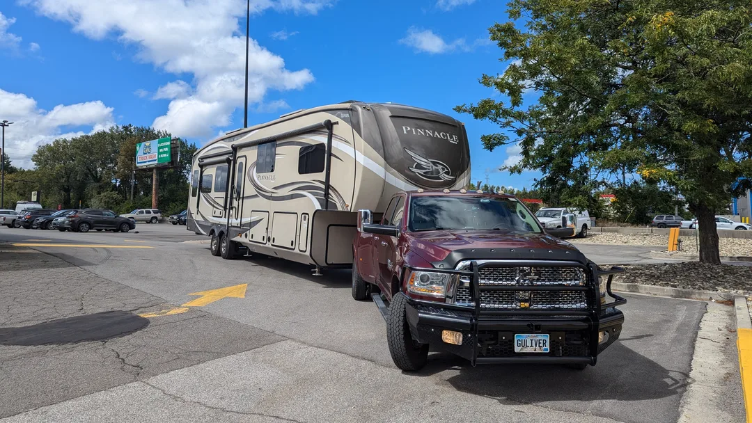 Red dually truck pulling a Jayco Pinnacle fifth wheel