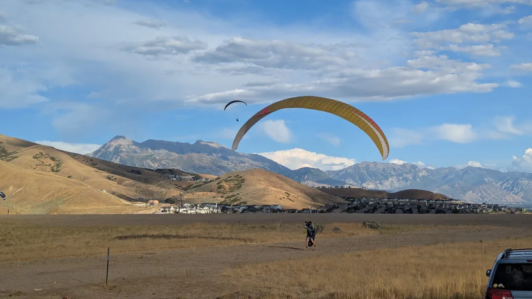 Two paragliders close to land