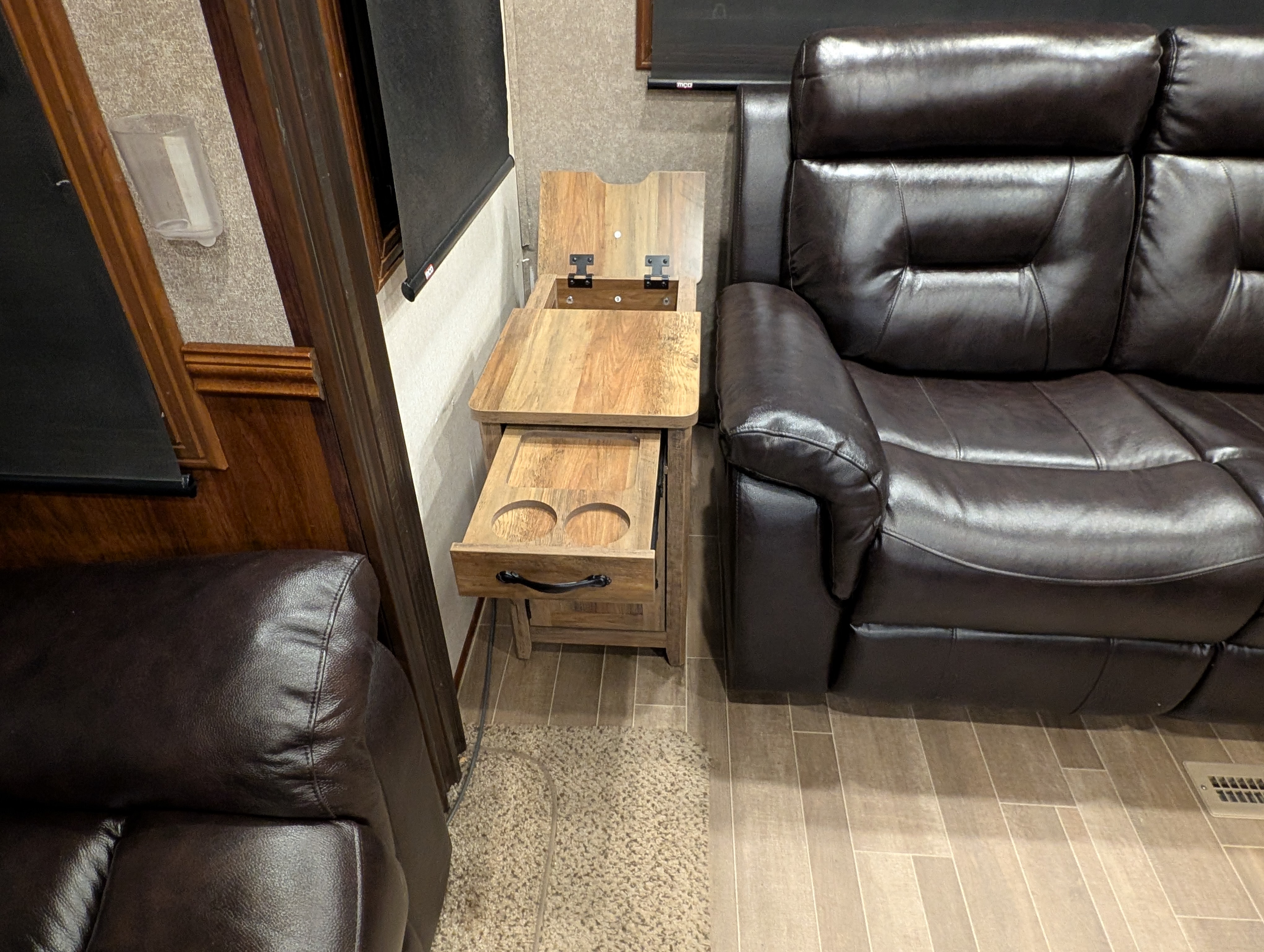 An end table with cup holders and a charging station