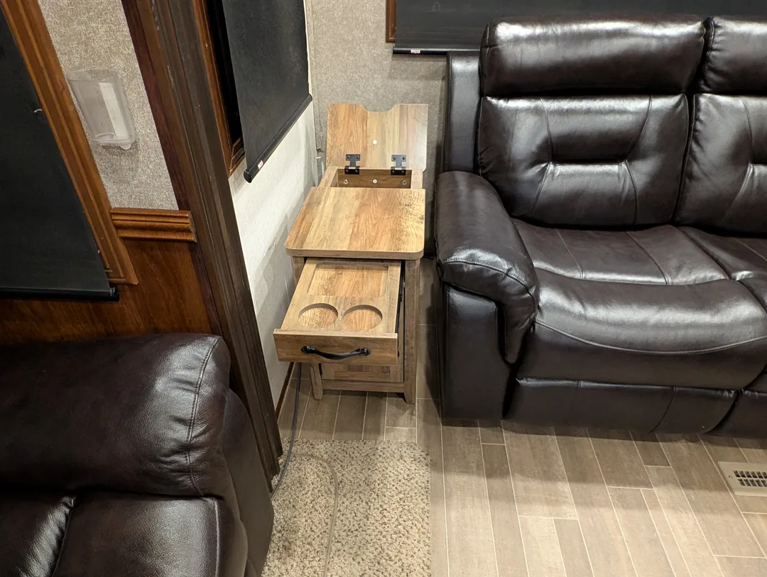 An end table with cup holders and a charging station