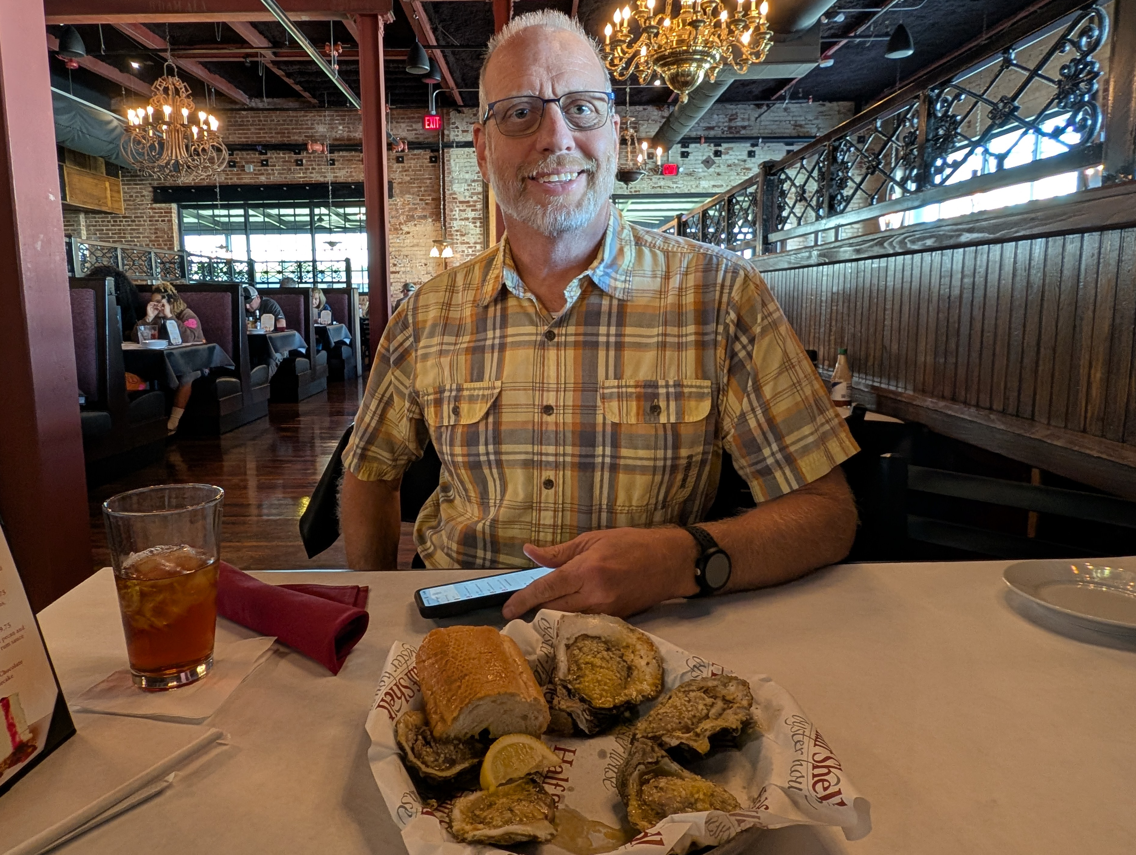 Bob Gates with a plate of grilled oysters at the Half Shell Oyster House in Cullman, Alabama.