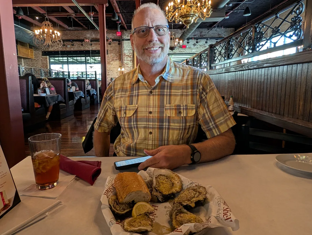 Bob Gates with a plate of grilled oysters at the Half Shell Oyster House in Cullman, Alabama.
