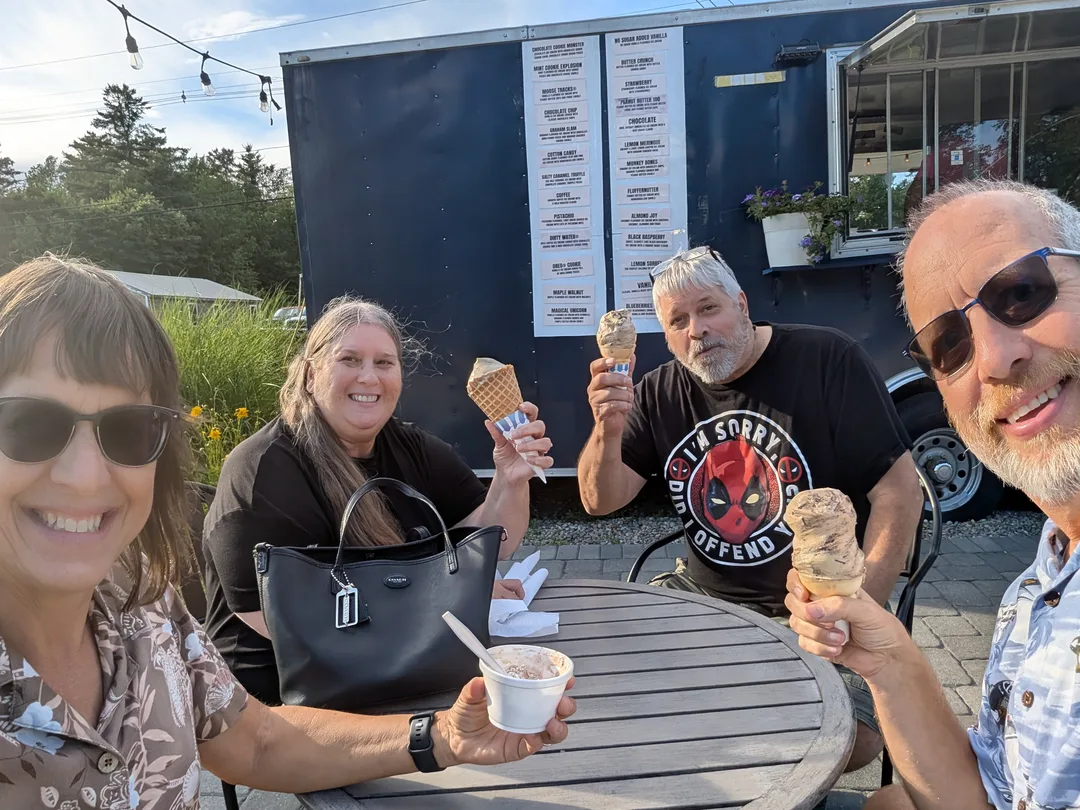 Four people eating ice cream at a New England ice cream shack