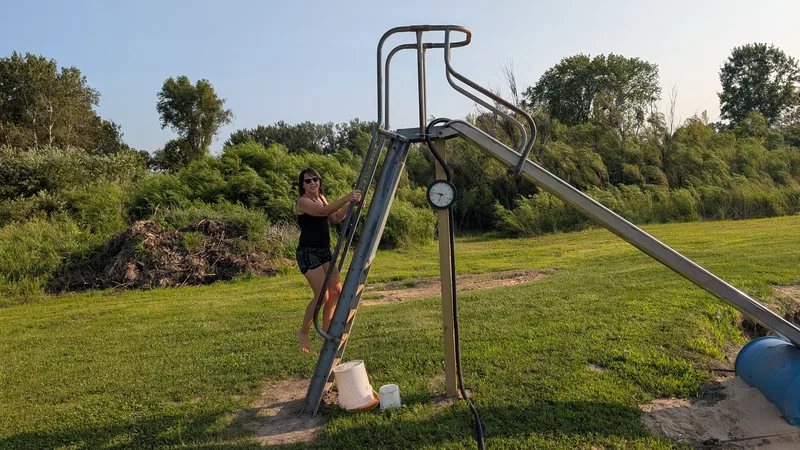 Woman climbing the ladder on a metal slide