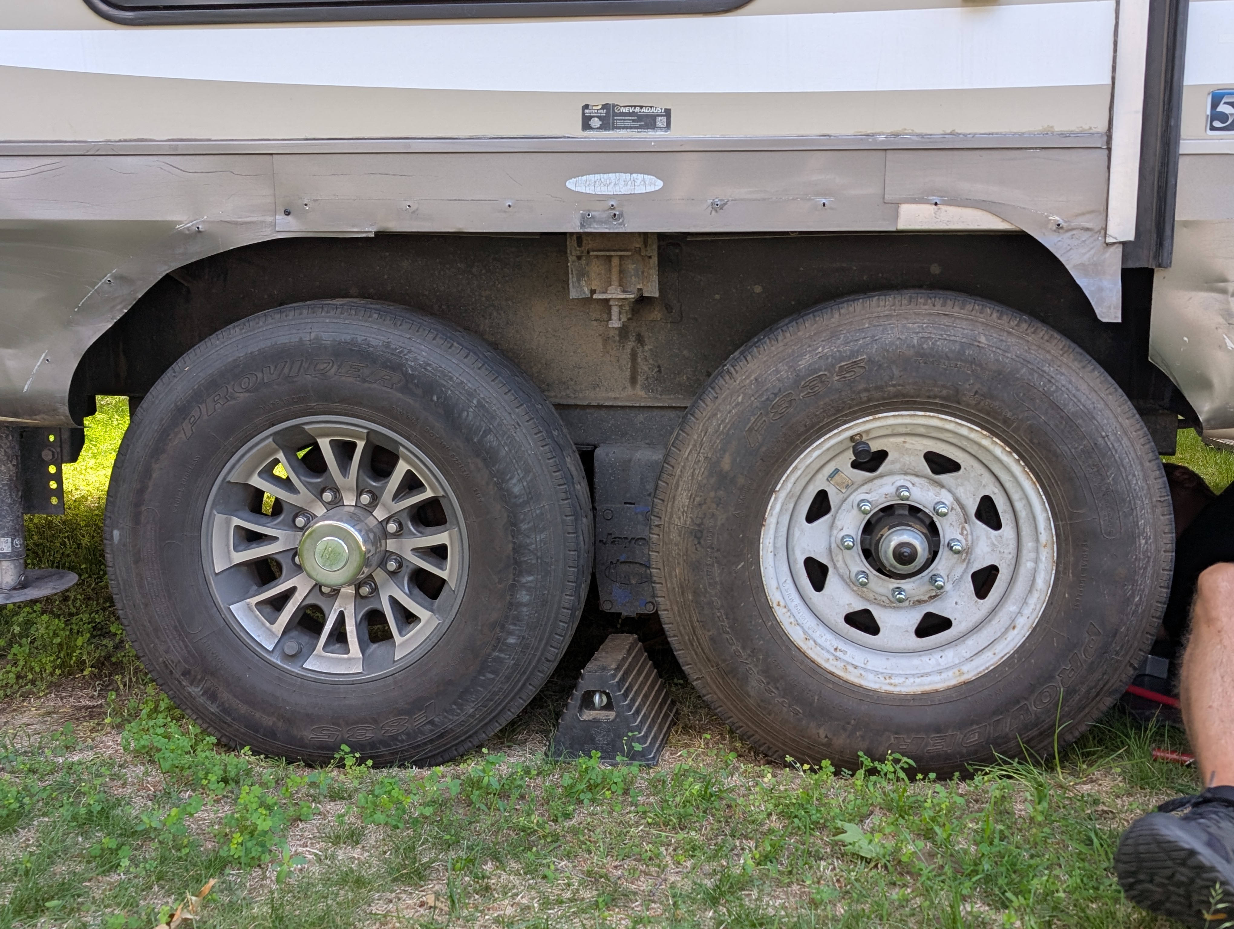 Two trailer tires with mismatched rims