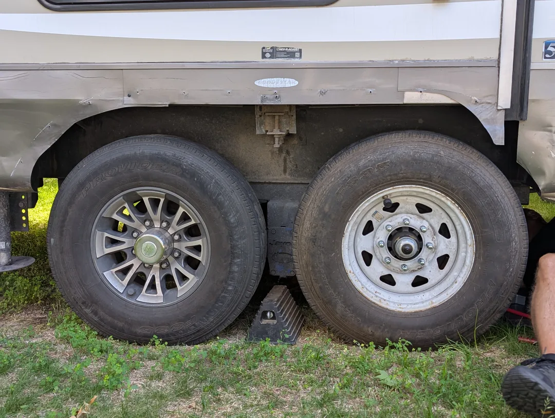 Two trailer tires with mismatched rims