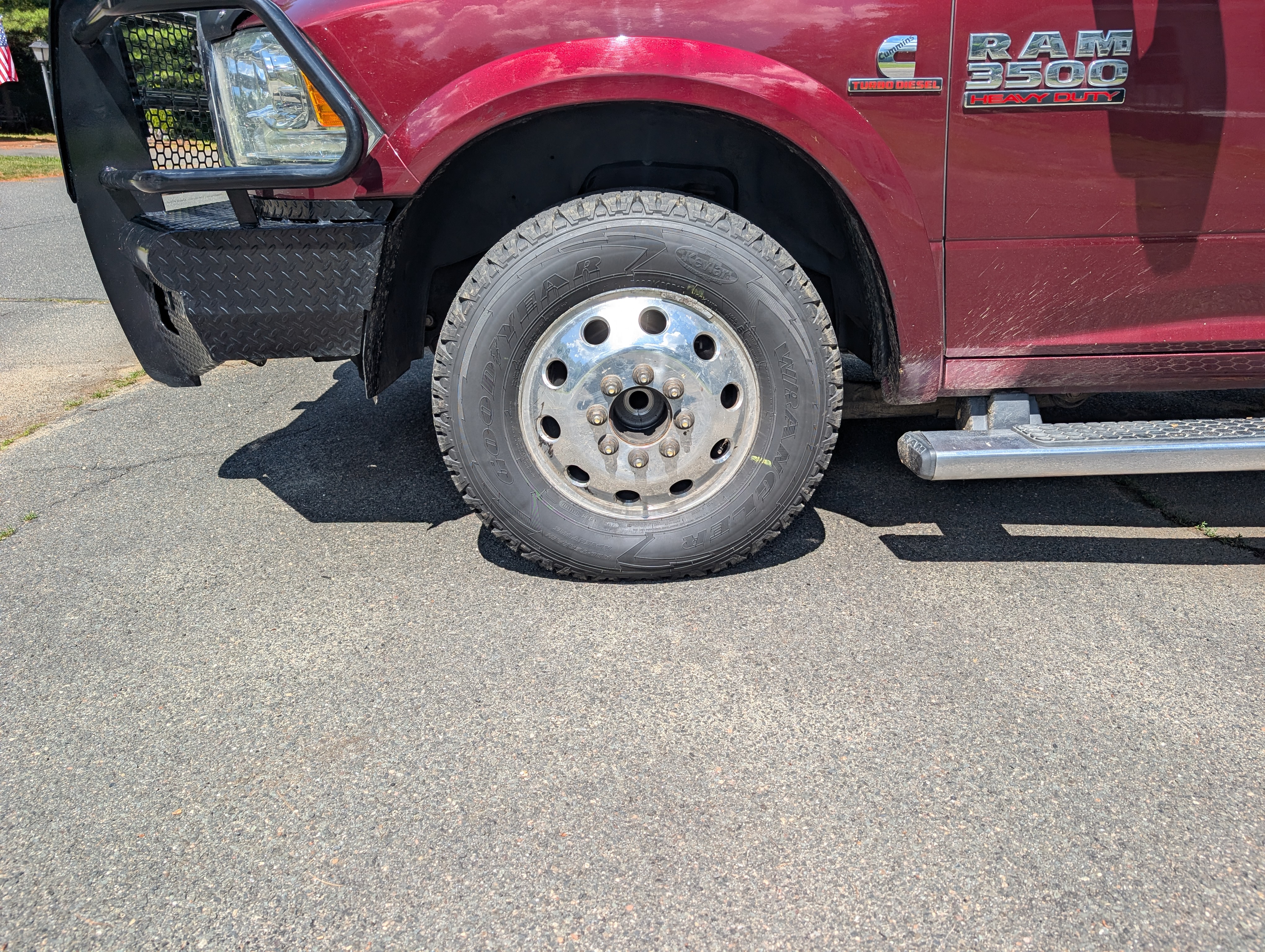A truck tire missing a hubcap