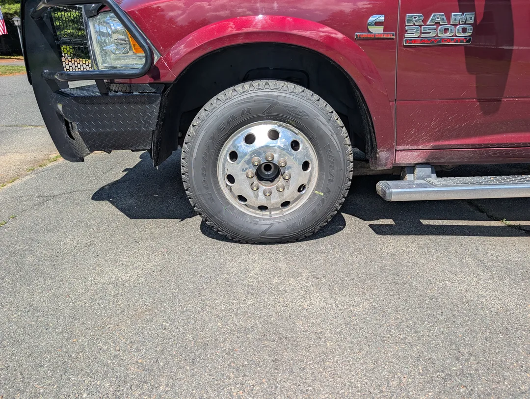 A truck tire missing a hubcap